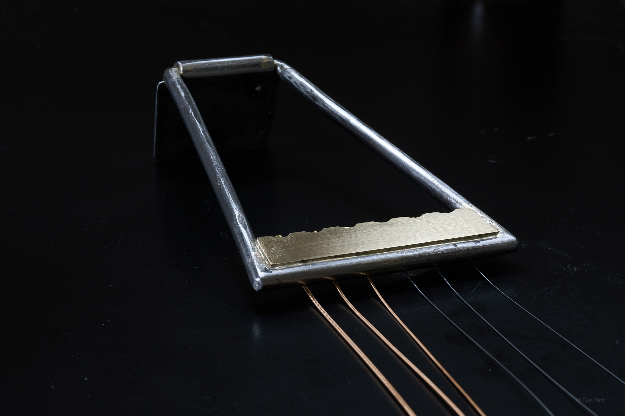 Tailpiece on black tabletop.